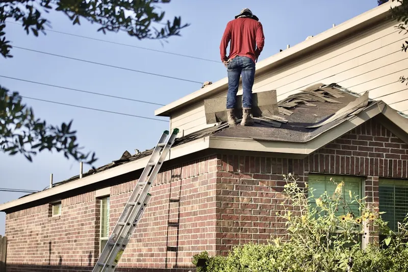 Professional roofer working on a residential roof in Sterling Ranch
